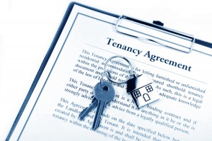 Tenancy agreement and key with symbolic house keyring